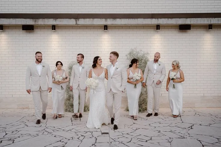 Bride and groom walking with their bridal party in coordinated outfits, capturing the elegance and organization of an On the Day Wedding Coordinator Australia.