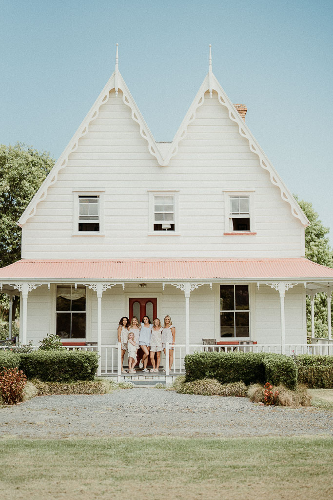 Bridal party posing in matching outfits on the porch of a charming historic house, showcasing the seamless planning of an On the Day Wedding Coordinator Adelaide.