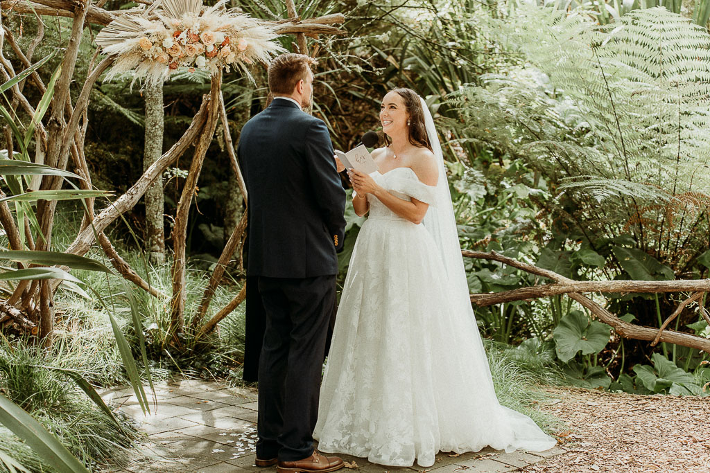 Bride reading heartfelt vows to the groom in a serene garden setting, with every detail managed by an On the Day Wedding Coordinator Perth.