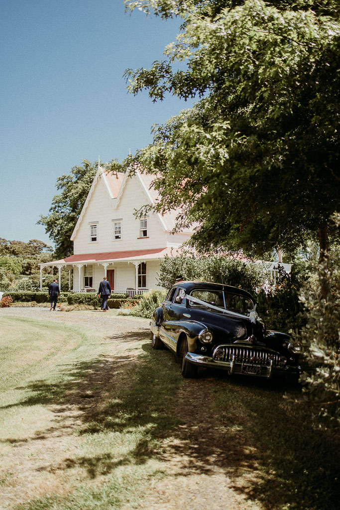 Classic vintage car parked in front of a charming heritage-style venue, showcasing a meticulously planned celebration by an On the Day Wedding Coordinator Sydney.